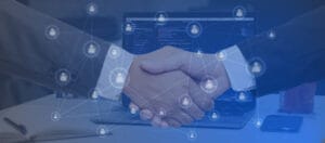 Business handshake over a laptop with digital network overlay, symbolizing digital partnership and connected technology.