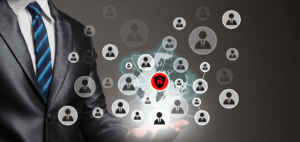 Businessman holding a digital network with user icons and a central red security shield representing secure global user access