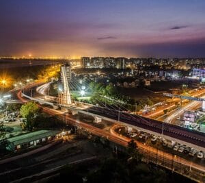 Surat: The Emerging IT Powerhouse of Gujarat Aerial night view of Surat city showcasing modern infrastructure, roads, and city lights symbolizing rapid urban and tech growth.